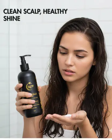 A woman applying Divine Era Herbal Anti-Dandruff Shampoo, showcasing clean, shiny, and healthy-looking hair after use. Promotes clean scalp and healthy shine.
