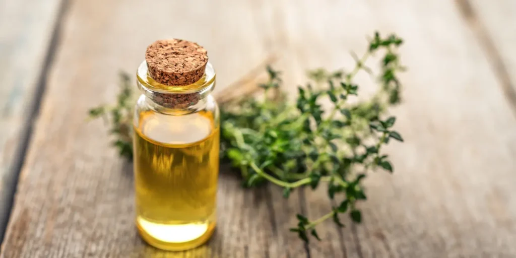 Golden oil with fresh herbs, representing a natural, Vitamin E-rich component like wheat germ oil for skin repair.