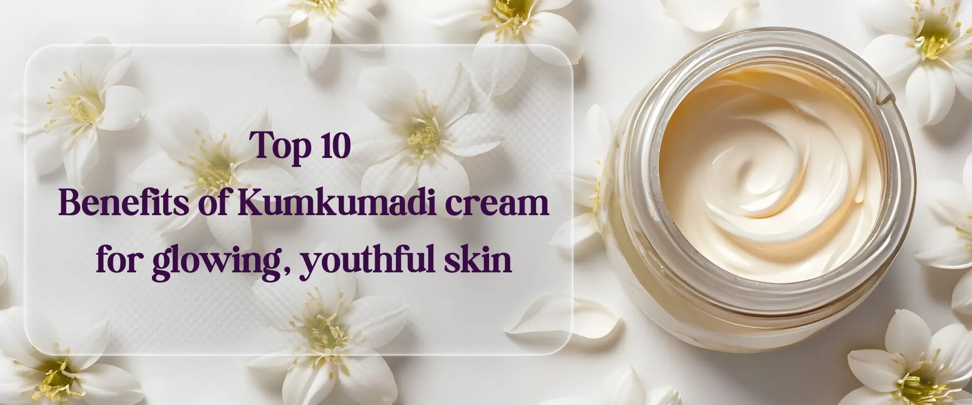 Close-up of a jar of rich, swirling Kumkumadi Cream for Face on a bright white background, surrounded by delicate white flowers, visually representing glowing and youthful skin benefits.